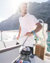 A sailor handling the lines on board a sailing boat on Lake Garda