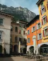 Historic houses in Riva del Garda set against a mountain backdrop